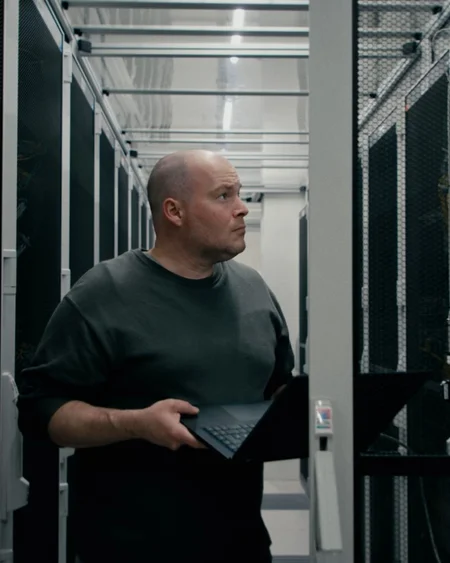 Technician with a laptop in the data centre